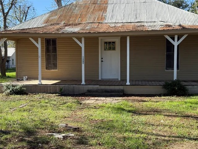 a view of a house with potted plants