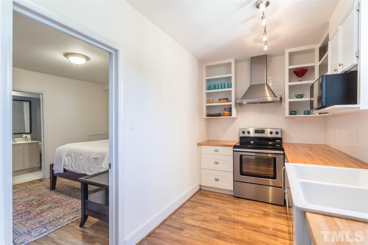 2807 Lewis Farm Road Raleigh, NC 27607 - Photo 22 of 30 a kitchen with stainless steel appliances granite countertop a stove and a refrigerator