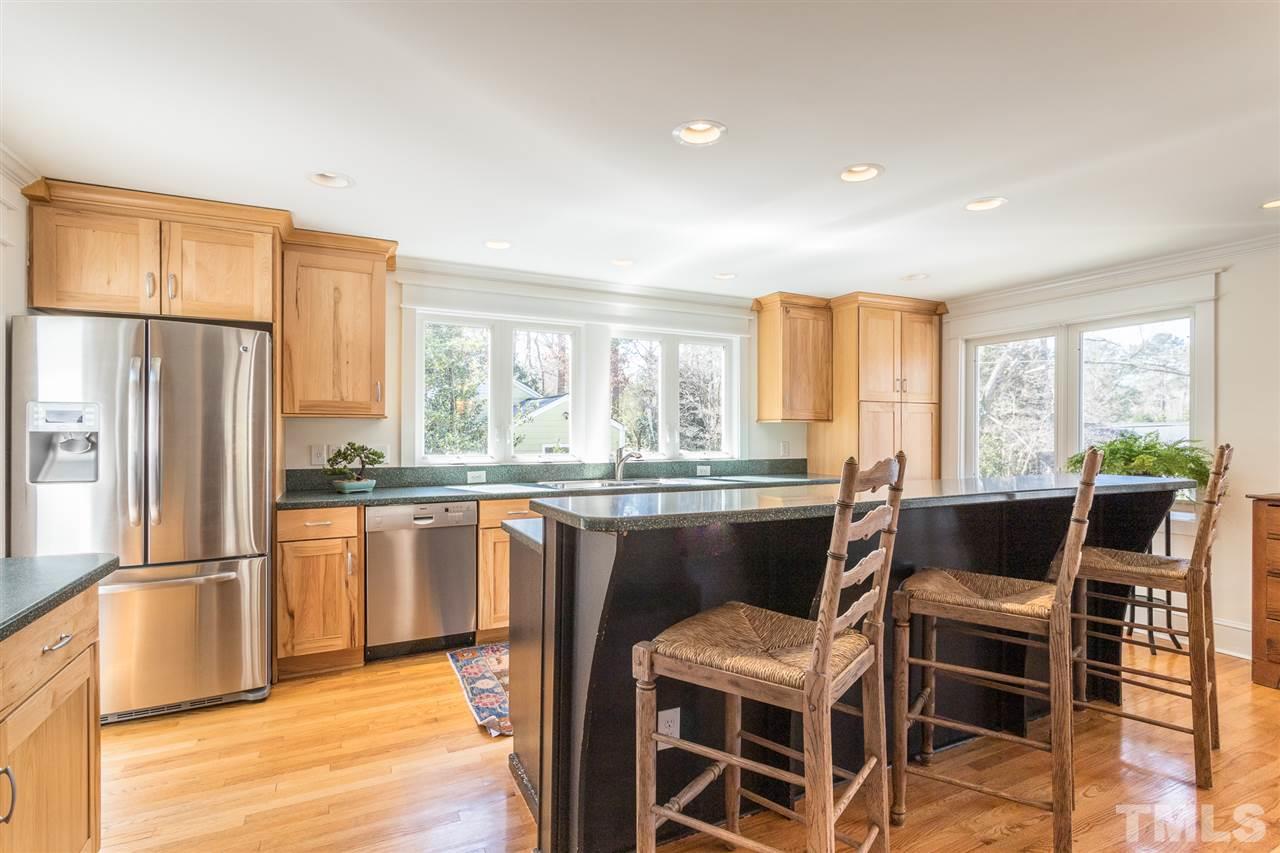 2807 Lewis Farm Road Raleigh, NC 27607 - Photo 8 of 30 a kitchen with a table chairs refrigerator and microwave