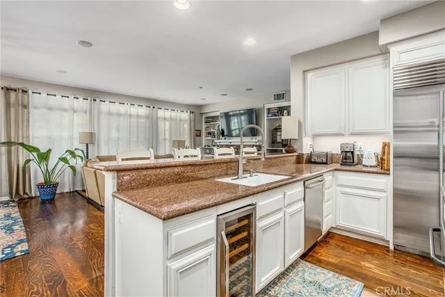 a kitchen with stainless steel appliances granite countertop a sink stove and cabinets