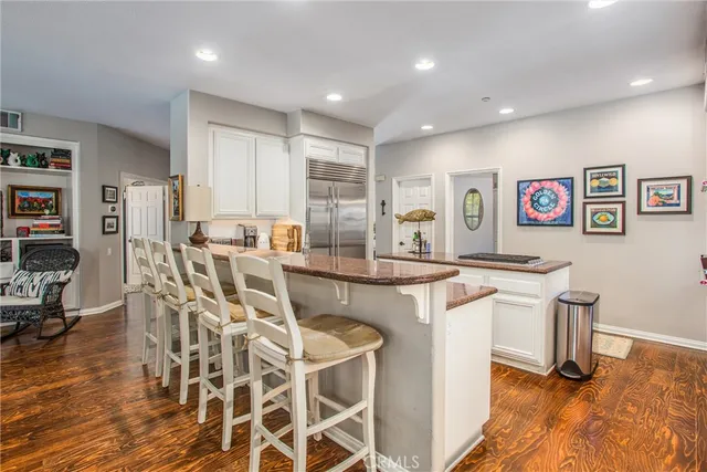 a view of a kitchen with granite countertop a table and chairs in it