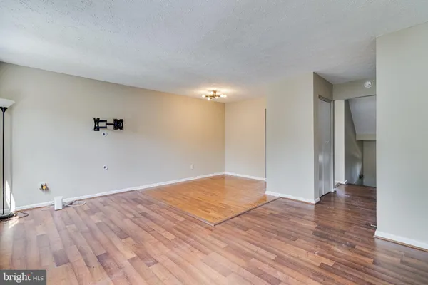 a view of an empty room and wooden floor