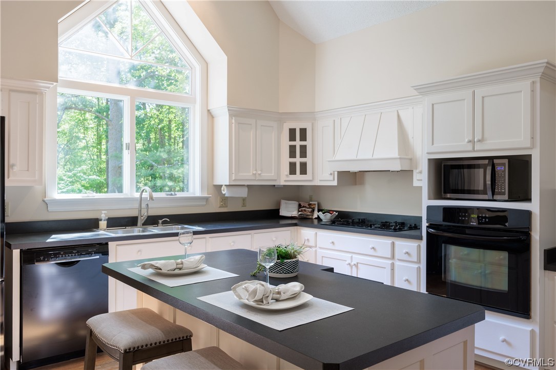 380 Ziontown Road Henrico, VA 23229 - Photo 19 of 44 a kitchen with stainless steel appliances granite countertop a stove a sink a microwave a dining table and chairs