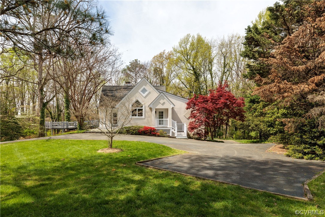 380 Ziontown Road Henrico, VA 23229 - Photo 4 of 44 a view of a white house with a big yard and large trees