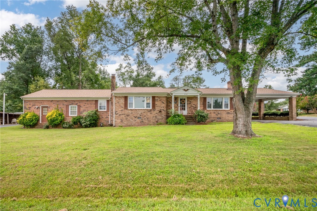 Brick exterior residence with a covered carport, m