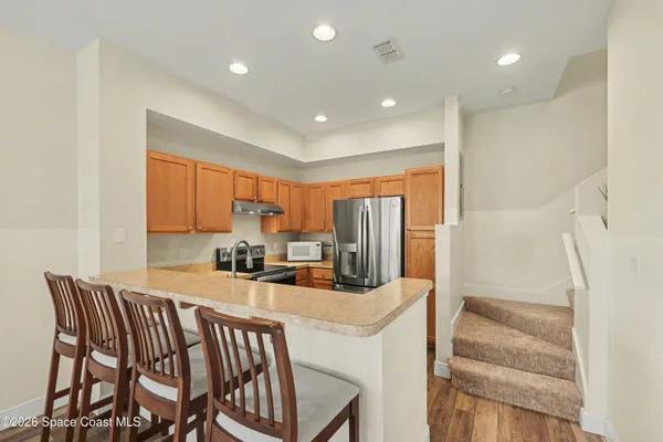 a kitchen with a table chairs sink and cabinets