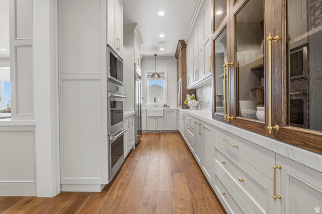 115 East Hidden Ridge Lane, Unit 42 Mapleton, UT 84664 - Photo 12 of 103 Galley kitchen with wood-finish flooring and integrated stainless steel appliances