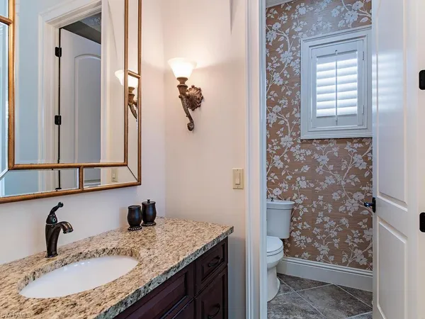 a bedroom with two beds and wooden floor