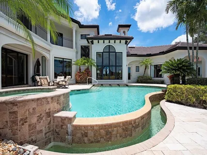 a view of a house with swimming pool and sitting area