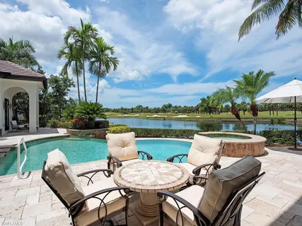 a view of a patio with swimming pool and furniture