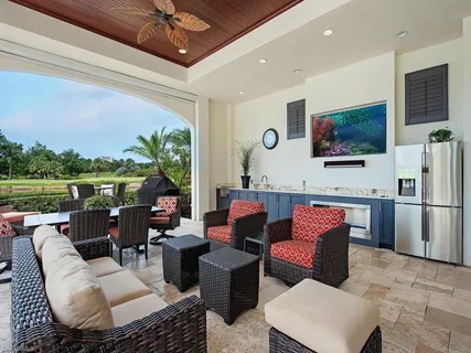 a living room with furniture a flat screen tv and a floor to ceiling window
