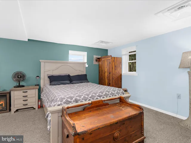 a bedroom with a large bed and a tv