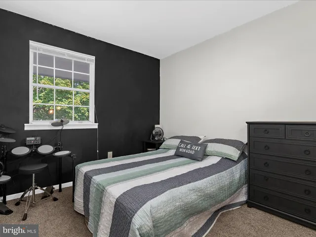 a bedroom with a bed and a table