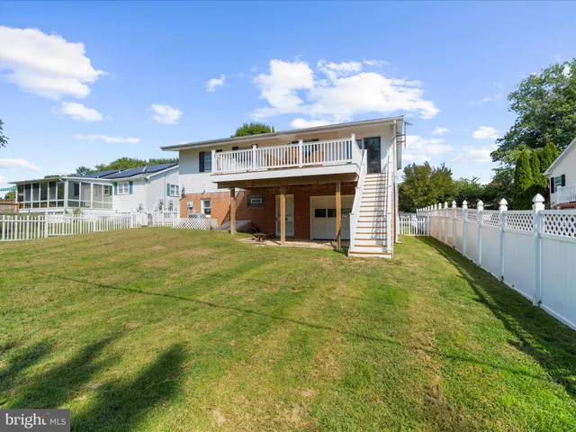 a view of a house with a backyard and a small yard