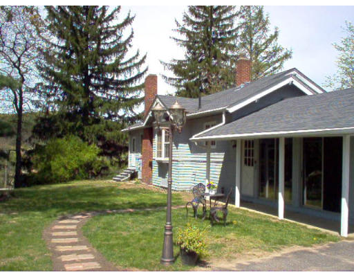 121 Palmer Road Monson, MA 01057 - Photo 3 of 10 front view of a house with a yard