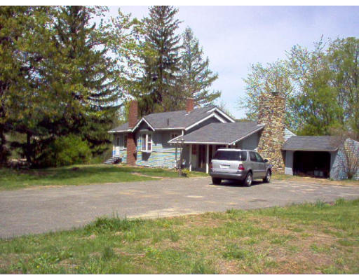 121 Palmer Road Monson, MA 01057 - Photo 6 of 10 a view of a house with a yard and large trees