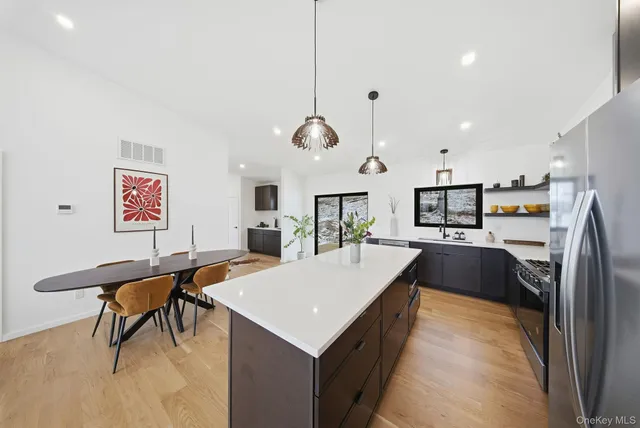 a large kitchen with a table and chairs