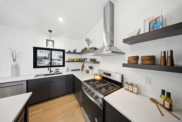 a kitchen with stainless steel appliances a sink stove and cabinets