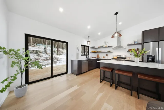 a kitchen with a table chairs refrigerator and sink