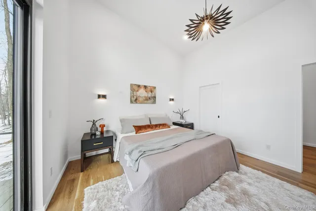 a bedroom with a bed and a chandelier