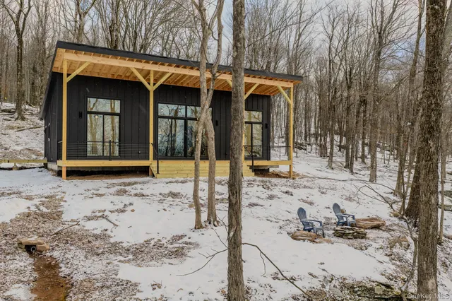 a view of a house with a yard covered in snow