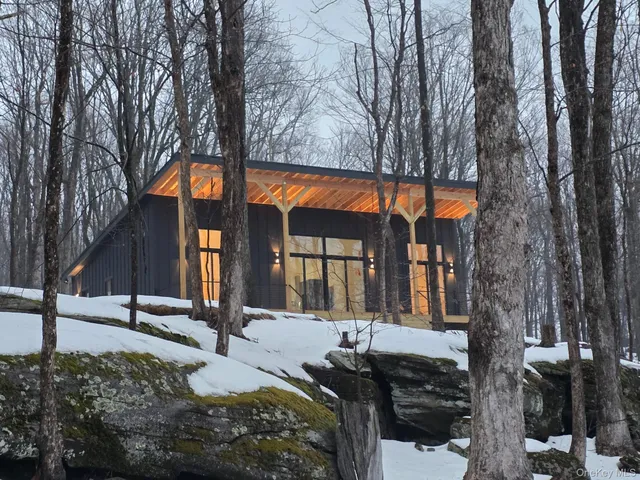 a front view of a house with a tree