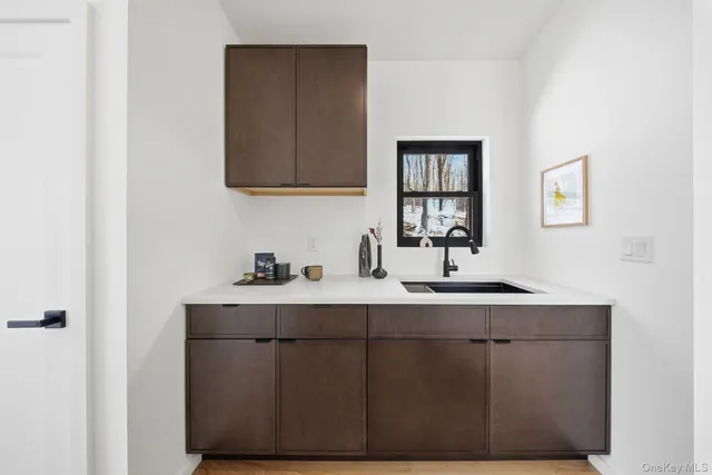 a kitchen with a sink cabinets and a window