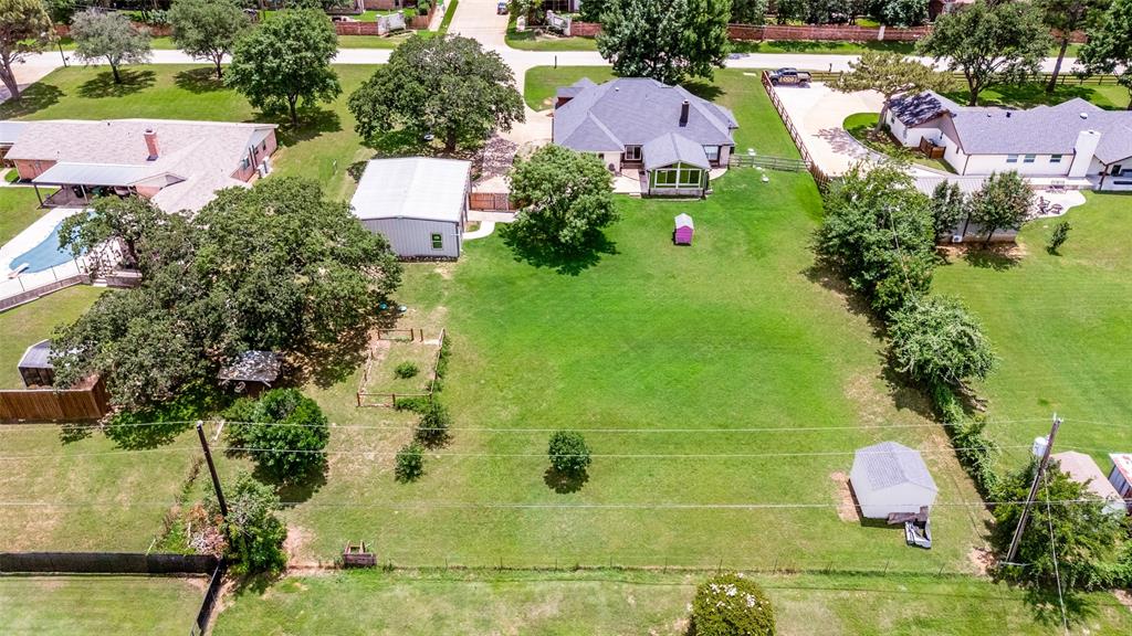 5643 West Caylor Road Fort Worth, TX 76244 - Photo 36 of 37 Expansive green lawn surrounds the main residence featuring a dark gray shingle roof