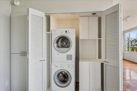 a view of a hallway with washer and dryer