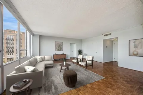 a living room with furniture rug and window