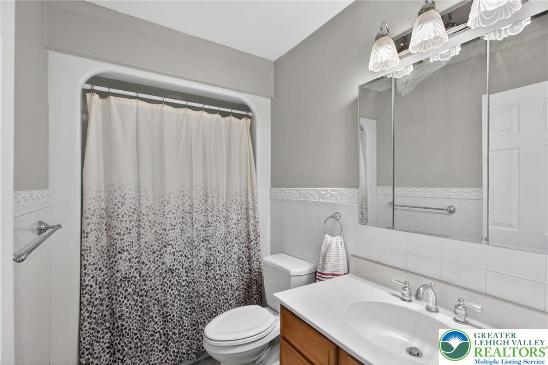 5255 Landis Mill Road Bethlehem, PA 18015 - Photo 21 of 50 a bathroom with a sink a toilet a mirror and shower