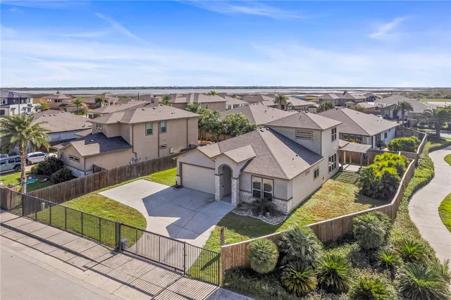 an aerial view of a house with swimming pool and outdoor seating