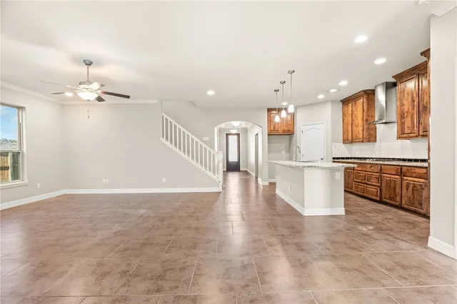 a kitchen with stainless steel appliances granite countertop a stove a sink and a refrigerator