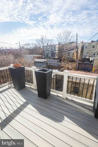 a view of balcony with furniture and wooden floor