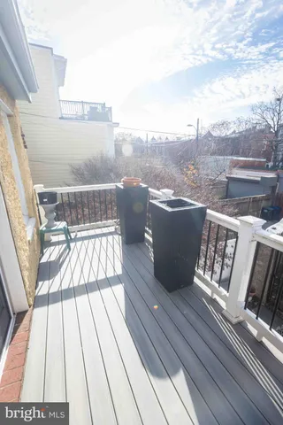 a view of a balcony with wooden floor