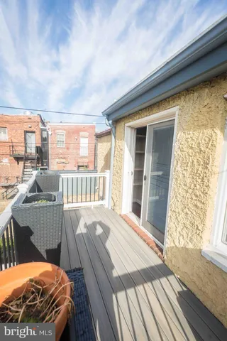 a view of a balcony with wooden floor and fence