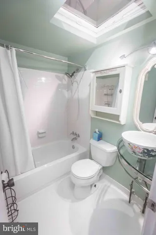 a bathroom with a toilet a sink and bathtub