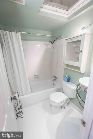 a bathroom with a sink a toilet and mirror