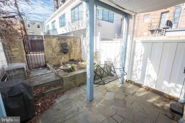 a view of a room that has a bench and windows