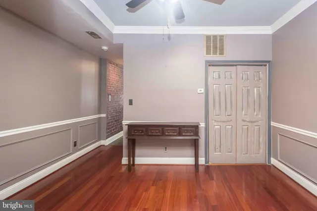 a view of an empty room with wooden floor