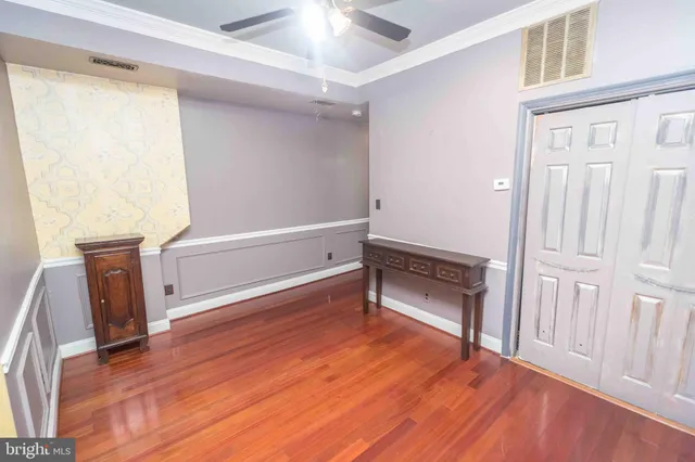 a room with wooden floor and furniture