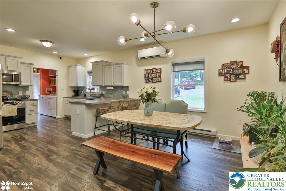 318 Church Road Kunkletown, PA 18058 - Photo 15 of 51 An open-concept living space integrates a modern kitchen and a casual dining area with contemporary lighting.