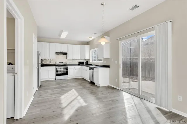 a large kitchen with cabinets and a sink