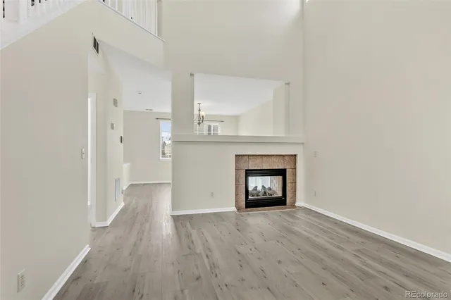 a view of an empty room with a fireplace and a window