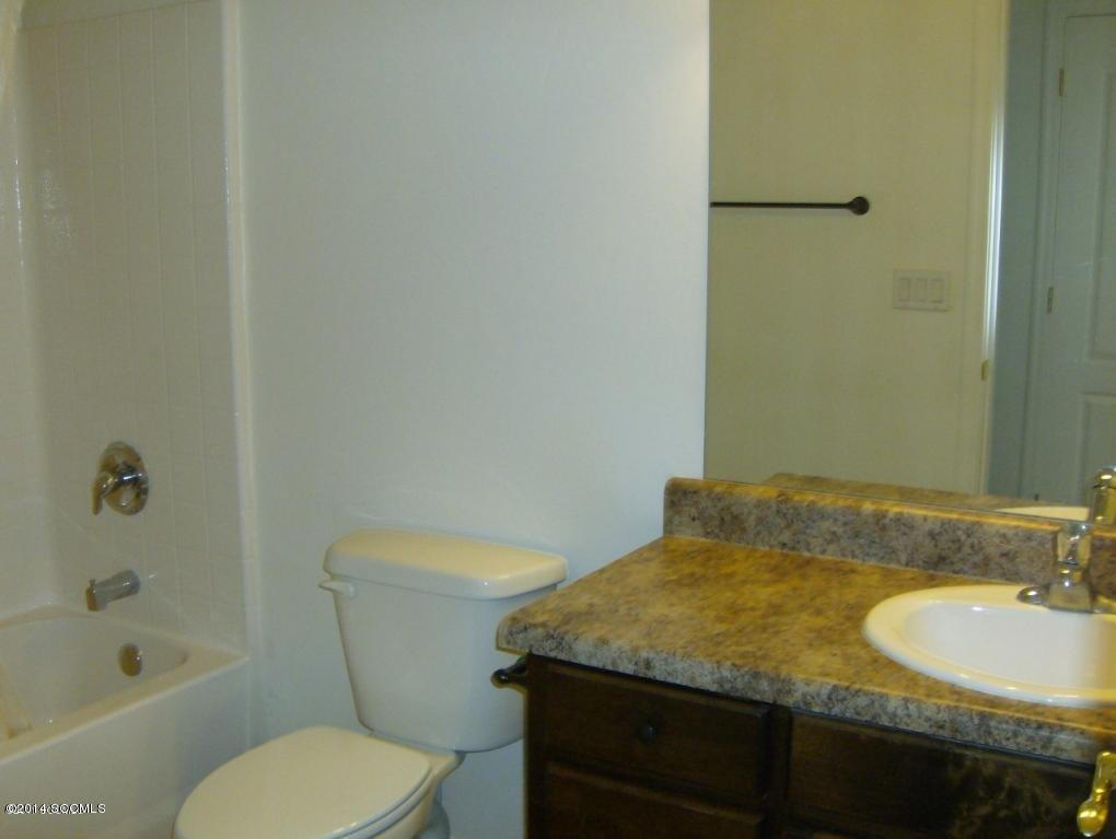 365 Via Papagayo Rio Rico, AZ 85648 - Photo 6 of 8 a bathroom with a granite countertop toilet a sink and bathtub