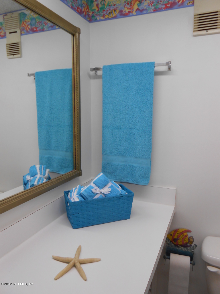 7175 A1A South, Unit E130 St. Augustine, FL 32080 - Photo 18 of 21 a bathroom with a sink and a mirror