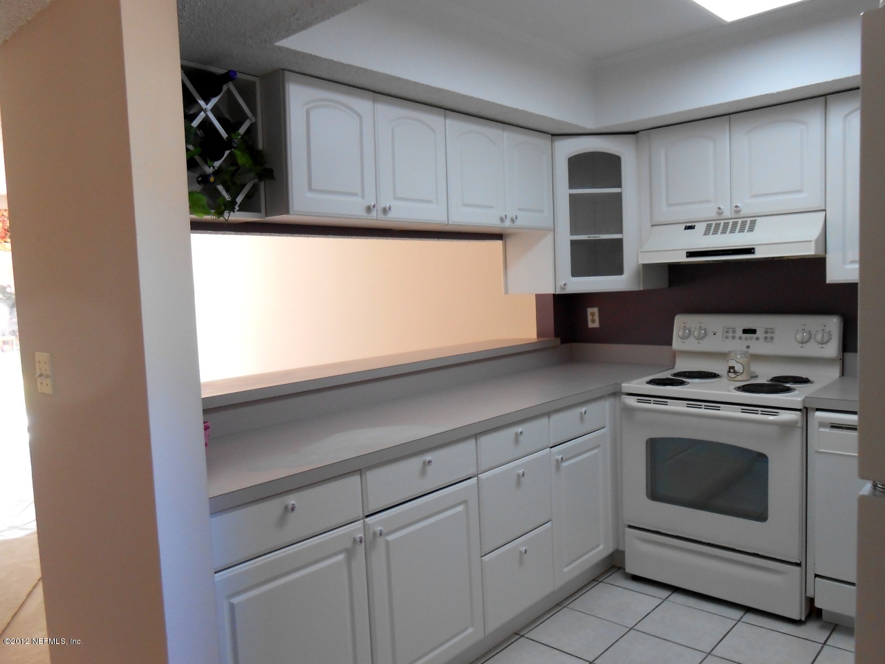 7175 A1A South, Unit E130 St. Augustine, FL 32080 - Photo 8 of 21 a kitchen with cabinets appliances and a window