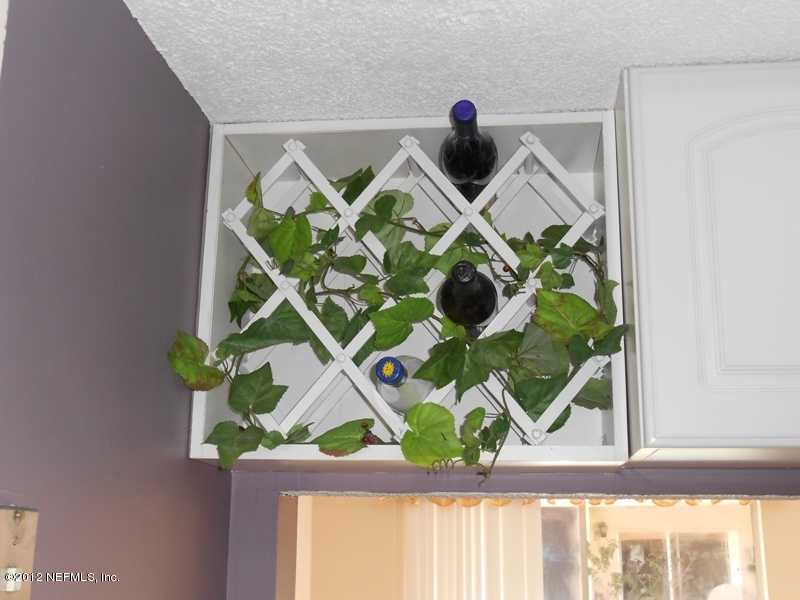 7175 A1A South, Unit E130 St. Augustine, FL 32080 - Photo 10 of 21 a vase of flowers sitting on a table