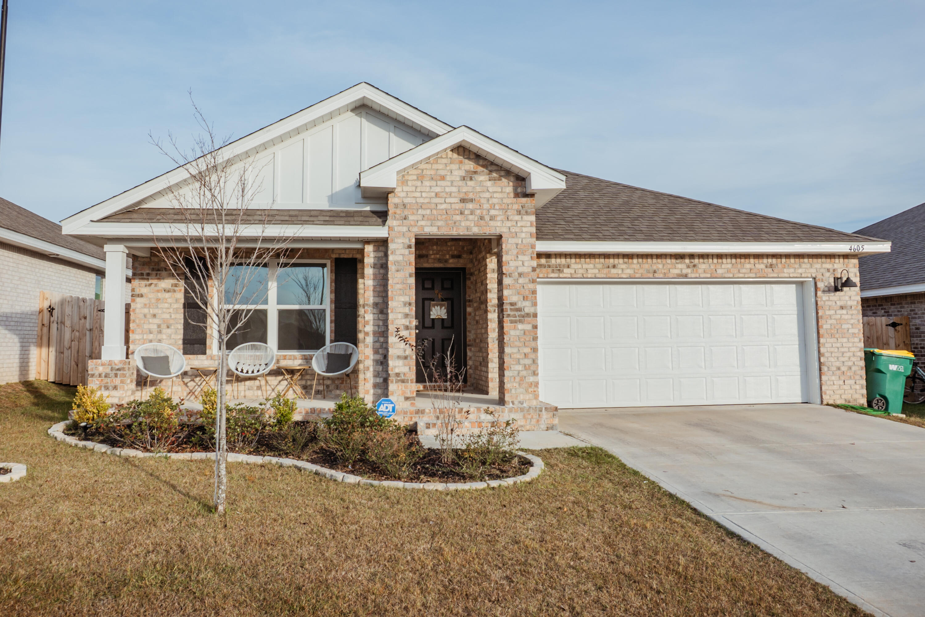 a front view of a house with garden and plants
