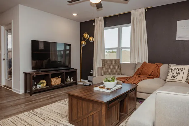 a living room with furniture and a flat screen tv